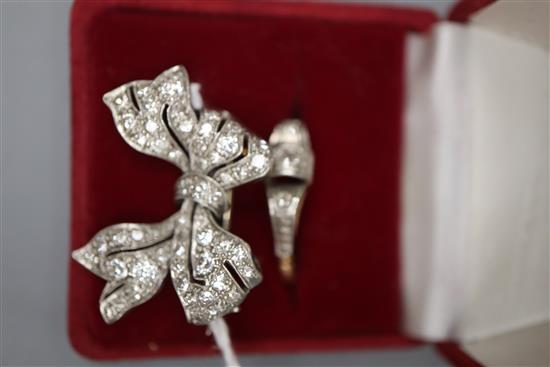 A white metal and diamond set bow brooch, 28mm, gross 5.7 grams and a 9ct and plat, three stone diamond ring